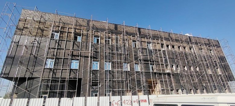 Structure complete, façade scaffolding up, cladding installation under way.